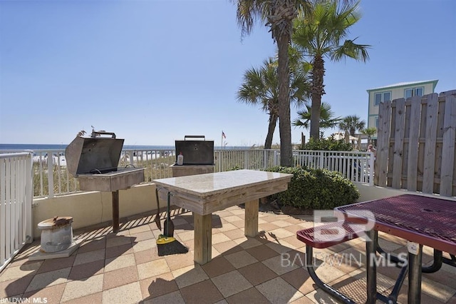 24720 Perdido Beach Blvd Unit 504, Orange Beach, AL 36561 - view of patio with outdoor dining area, a water view, and fence