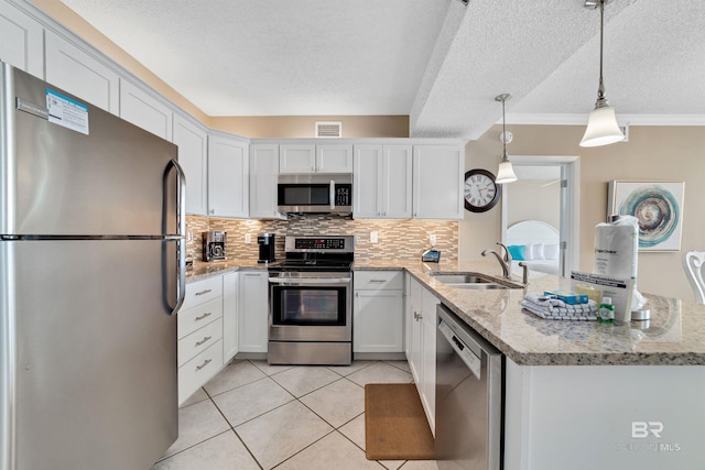 24720 Perdido Beach Blvd Unit 504, Orange Beach, AL 36561 - kitchen with appliances with stainless steel finishes, a sink, a peninsula, a textured ceiling, and decorative backsplash