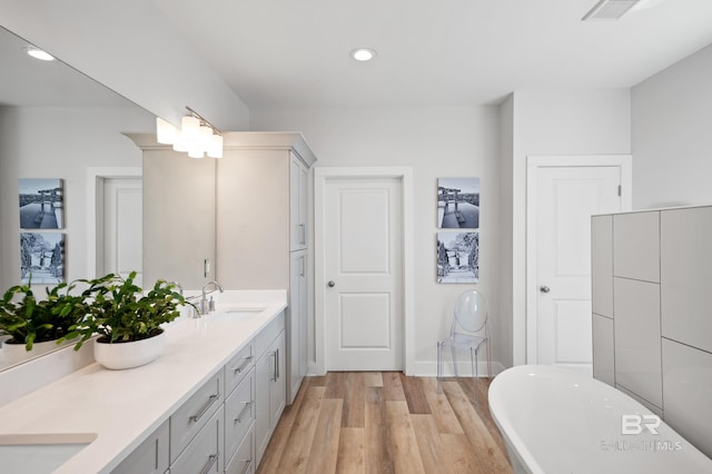 30531 Ono N Loop W, Orange Beach, AL 36561 - full bathroom featuring double vanity, a soaking tub, wood finished floors, and recessed lighting
