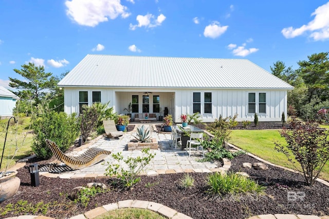 30531 Ono N Loop W, Orange Beach, AL 36561 - back of property featuring board and batten siding, a patio area, a ceiling fan, a metal roof, and outdoor lounge area
