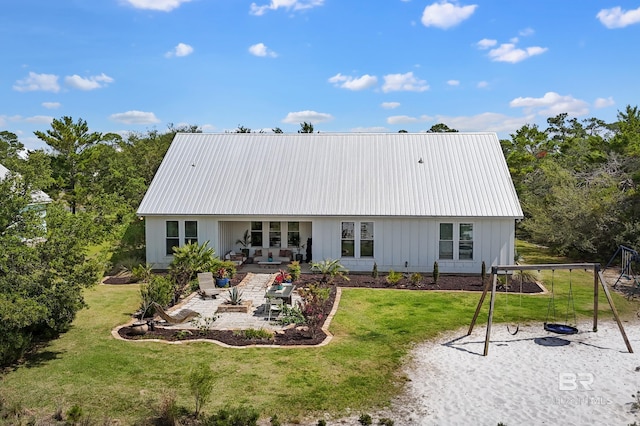 30531 Ono N Loop W, Orange Beach, AL 36561 - back of house with a playground, a patio, a yard, and a metal roof