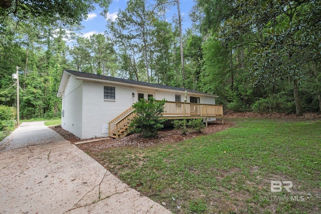 169 Buena Vista Dr, Daphne, AL 36526 - back of house featuring brick siding, a deck, concrete driveway, stairs, and a lawn