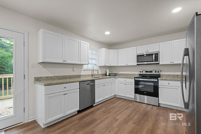 169 Buena Vista Dr, Daphne, AL 36526 - kitchen with appliances with stainless steel finishes, a sink, dark wood-type flooring, white cabinets, and light stone counters