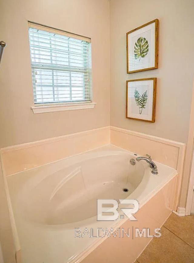 bathroom featuring a tub to relax in and tile patterned floors