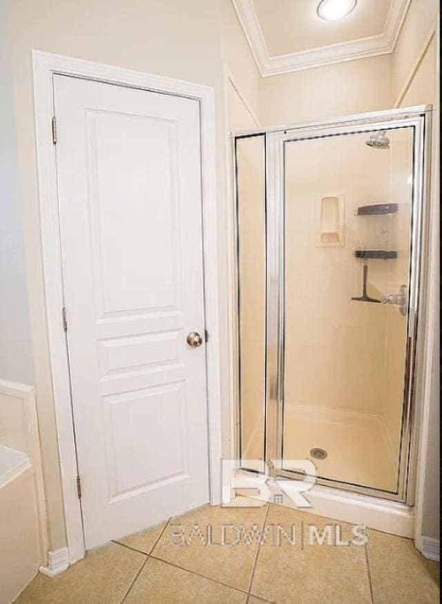 bathroom with crown molding, independent shower and bath, and tile patterned floors