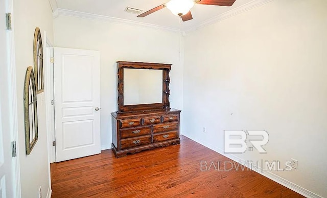 bedroom featuring dark wood-type flooring, ceiling fan, and ornamental molding