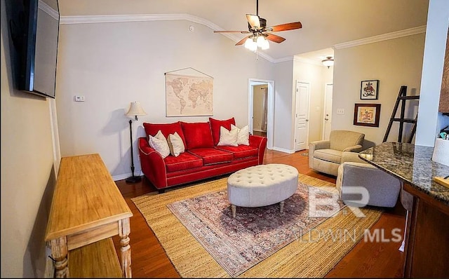 living room featuring crown molding, ceiling fan, wood-type flooring, and vaulted ceiling