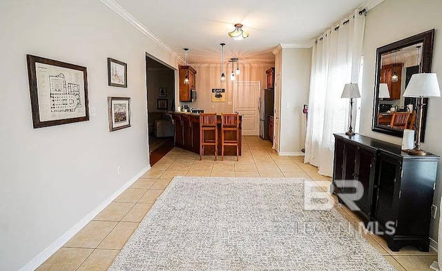 interior space with crown molding and light tile patterned flooring