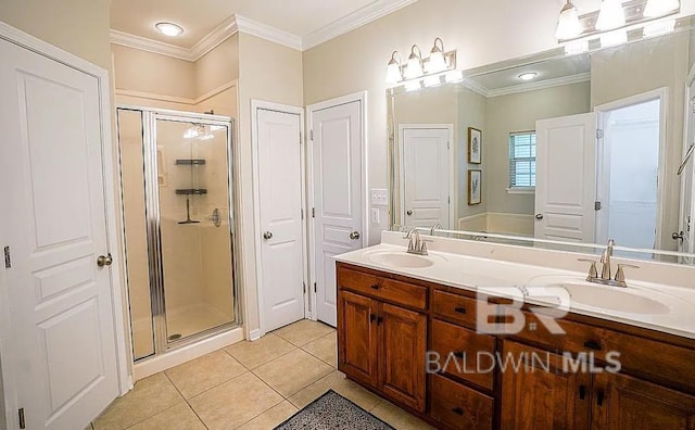 bathroom with a shower with shower door, ornamental molding, vanity, and tile patterned floors