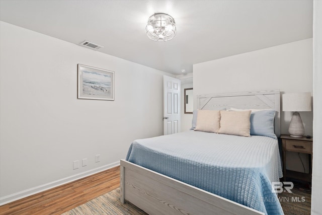 bedroom with wood-type flooring