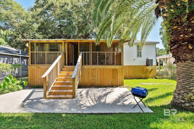 rear view of property featuring a yard and a patio