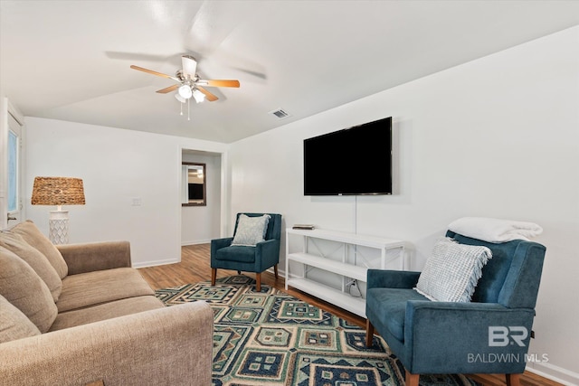 living room featuring hardwood / wood-style floors and ceiling fan