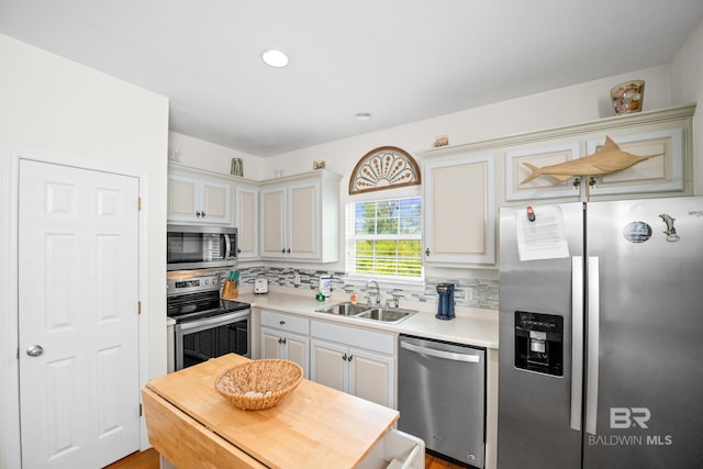 5601 State Highway 180 Unit 2802, Gulf Shores, AL 36535 - kitchen featuring stainless steel appliances, a sink, backsplash, light countertops, and recessed lighting