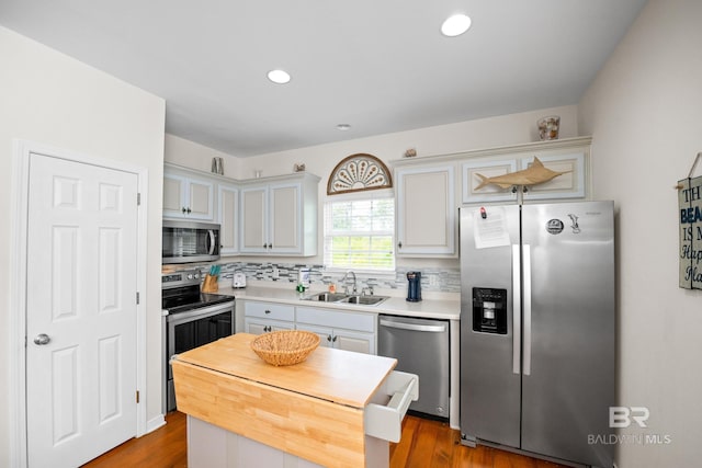 5601 State Highway 180 Unit 2802, Gulf Shores, AL 36535 - kitchen featuring appliances with stainless steel finishes, a sink, tasteful backsplash, light countertops, and white cabinetry