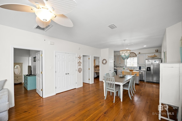 5601 State Highway 180 Unit 2802, Gulf Shores, AL 36535 - dining space featuring a ceiling fan, dark wood-style floors, and a chandelier