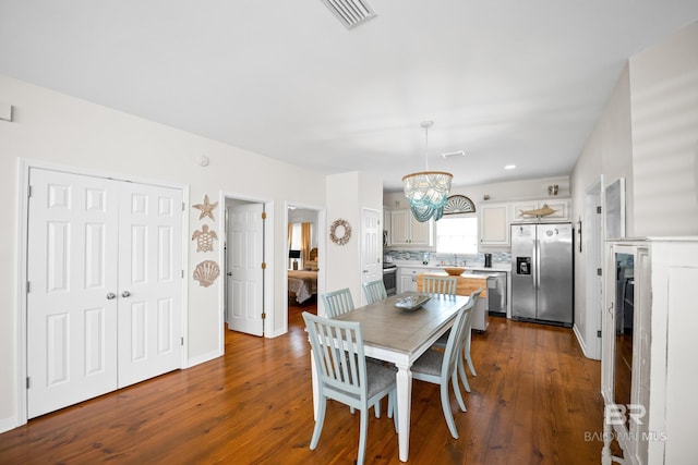 5601 State Highway 180 Unit 2802, Gulf Shores, AL 36535 - dining space with dark wood-style flooring and a chandelier