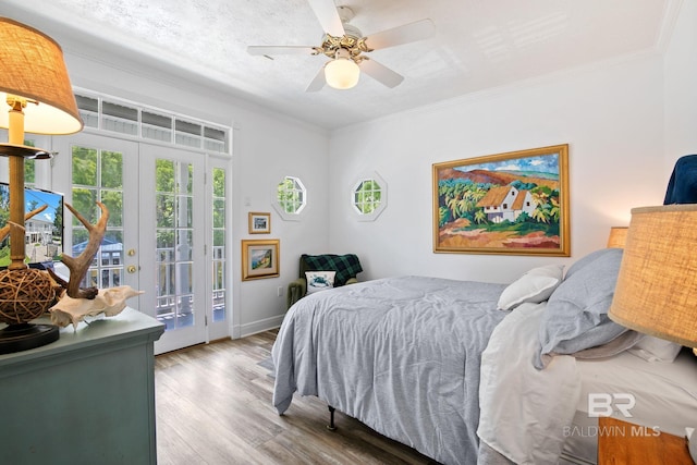 bedroom with access to exterior, french doors, light wood-type flooring, ceiling fan, and crown molding