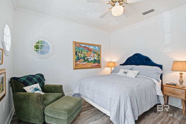 bedroom featuring dark hardwood / wood-style floors, ceiling fan, and ornamental molding