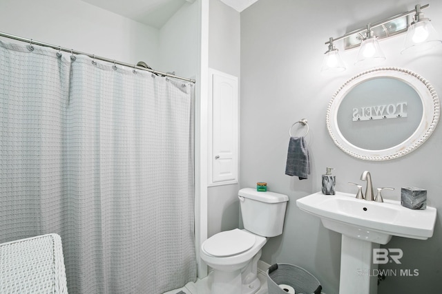 bathroom with a shower with shower curtain and toilet