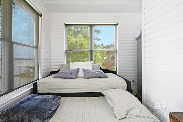 bedroom with wooden walls