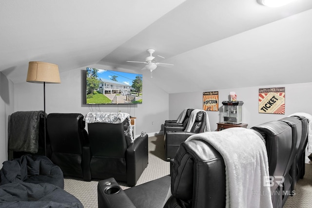 cinema room with ceiling fan, carpet, and vaulted ceiling