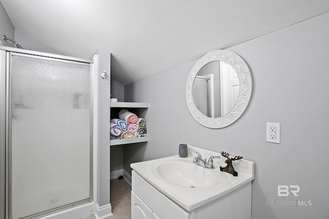 bathroom featuring tile patterned flooring, vanity, a shower with shower door, and lofted ceiling