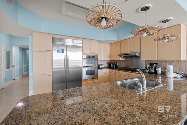28103 Perdido Beach Blvd Unit B 516, Orange Beach, AL 36561 - kitchen with stainless steel appliances, light brown cabinets, under cabinet range hood, a sink, and backsplash