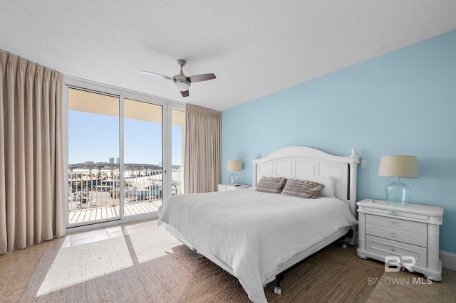 28103 Perdido Beach Blvd Unit B 516, Orange Beach, AL 36561 - bedroom with expansive windows, access to outside, tile patterned flooring, a textured ceiling, and a ceiling fan