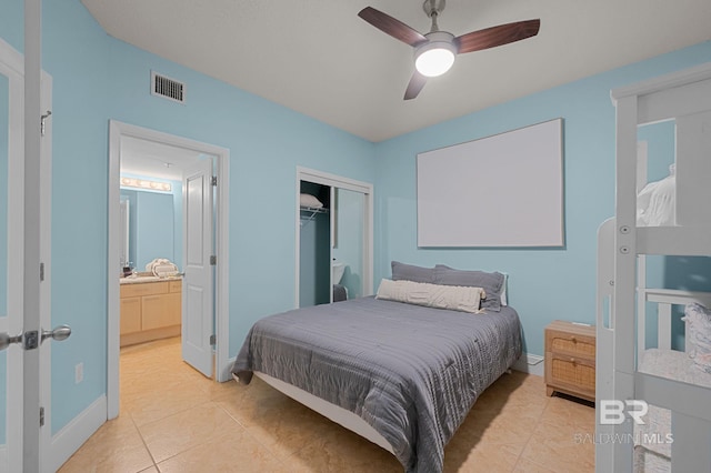 28103 Perdido Beach Blvd Unit B 516, Orange Beach, AL 36561 - bedroom featuring light tile patterned flooring, baseboards, a closet, ceiling fan, and connected bathroom