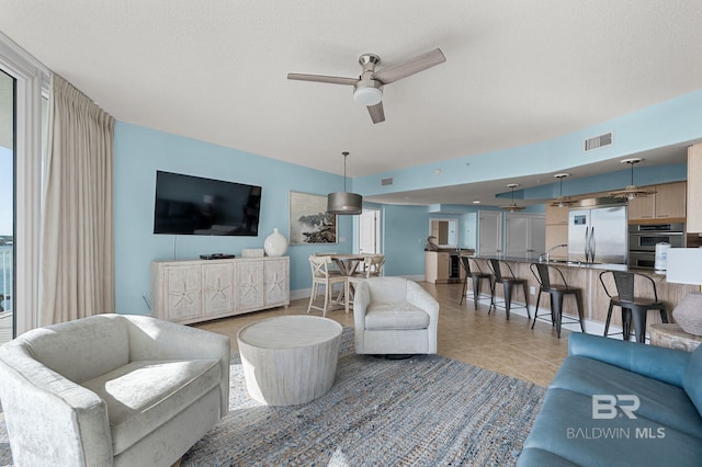 28103 Perdido Beach Blvd Unit B 516, Orange Beach, AL 36561 - living room featuring ceiling fan and light tile patterned flooring