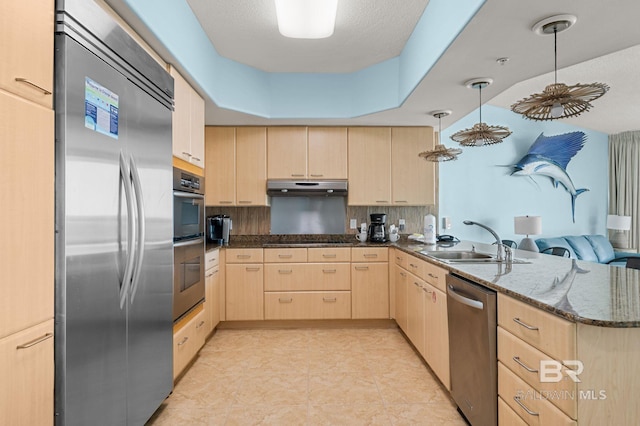 28103 Perdido Beach Blvd Unit B 516, Orange Beach, AL 36561 - kitchen featuring light brown cabinets, appliances with stainless steel finishes, a peninsula, under cabinet range hood, and backsplash