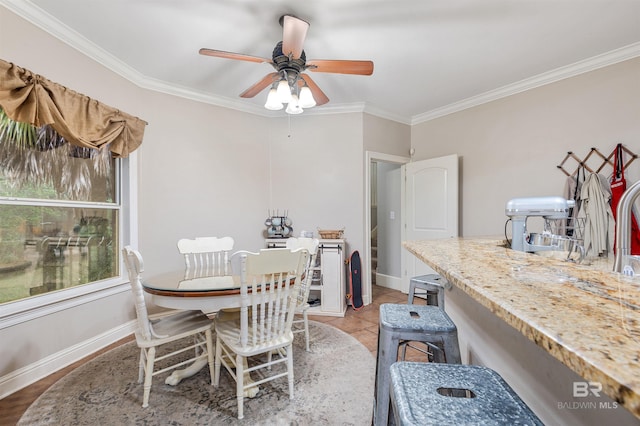 dining room with ceiling fan and ornamental molding