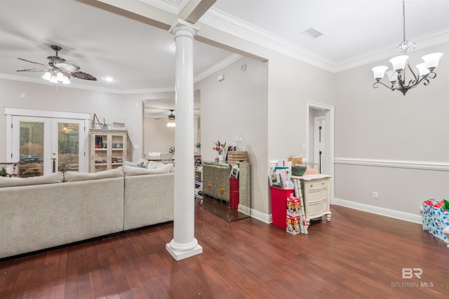 living room with ceiling fan with notable chandelier, dark hardwood / wood-style flooring, and decorative columns