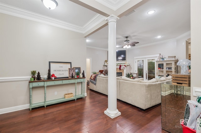 living room featuring ornate columns, ceiling fan, dark wood-type flooring, crown molding, and a tile fireplace