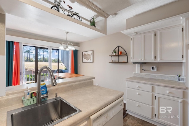 kitchen with white dishwasher, sink, white cabinetry, and hanging light fixtures