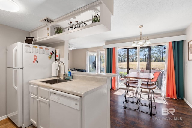 kitchen featuring white cabinetry, sink, white appliances, and a healthy amount of sunlight