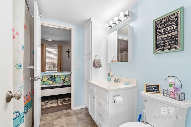 bathroom featuring vanity and toilet