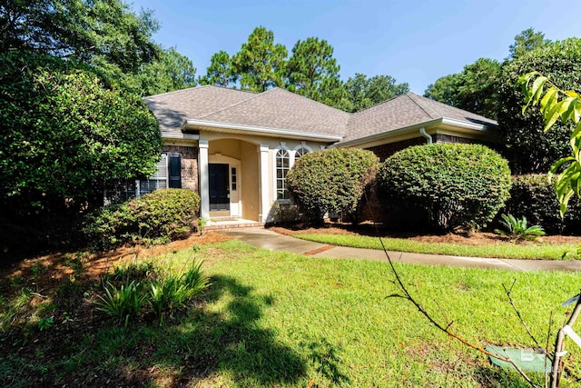 ranch-style home with a front lawn