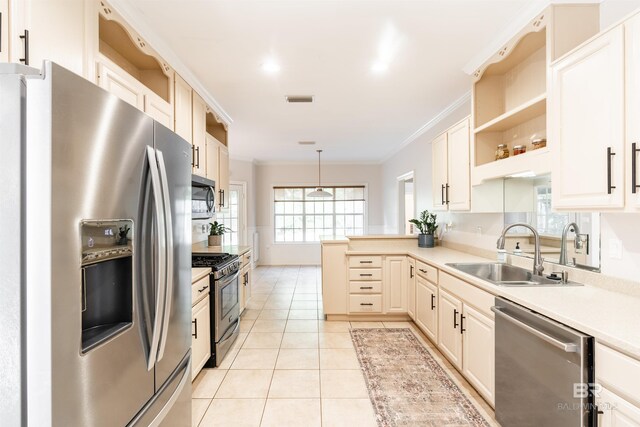 kitchen with sink, hanging light fixtures, stainless steel appliances, ornamental molding, and light tile patterned flooring