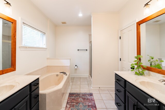 bathroom with vanity, tile patterned floors, and plus walk in shower