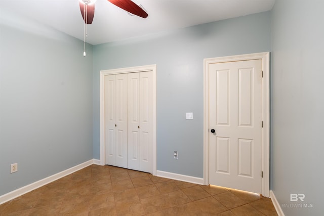 unfurnished bedroom featuring ceiling fan and light tile patterned floors