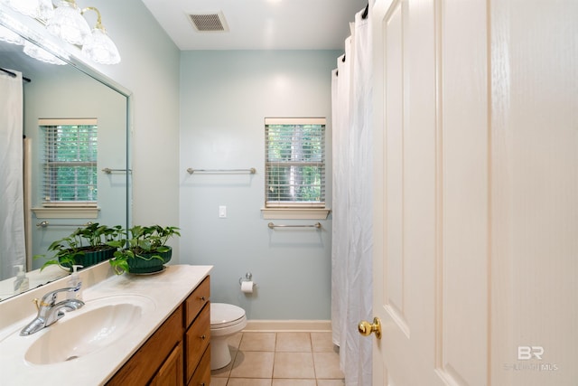 bathroom featuring toilet, vanity, and tile patterned floors