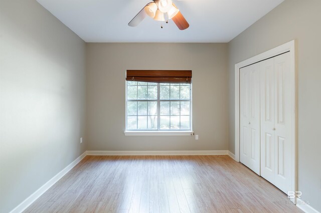 unfurnished bedroom with a closet, ceiling fan, and light wood-type flooring