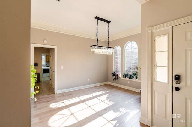 unfurnished dining area featuring crown molding and light hardwood / wood-style flooring