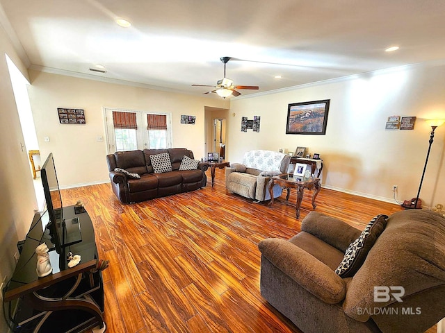 living room featuring ceiling fan, wood-type flooring, and crown molding