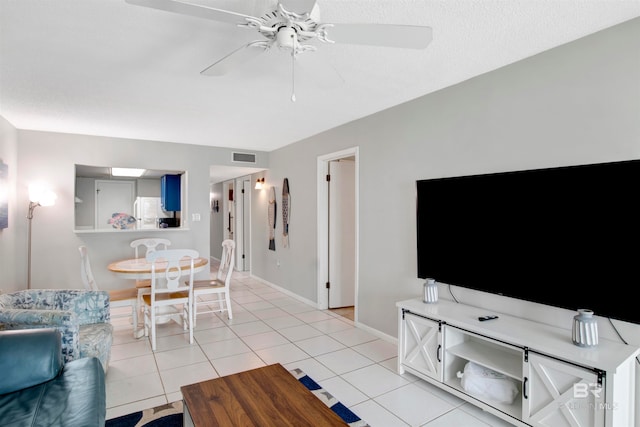 living room with light tile patterned flooring and ceiling fan