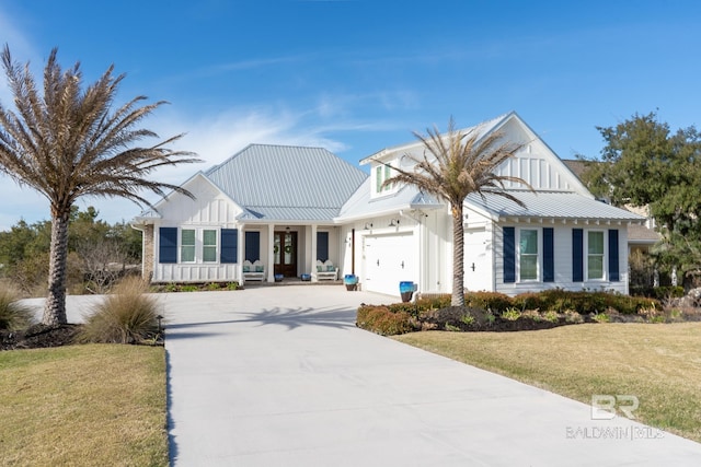 modern inspired farmhouse featuring driveway, an attached garage, board and batten siding, and a front yard