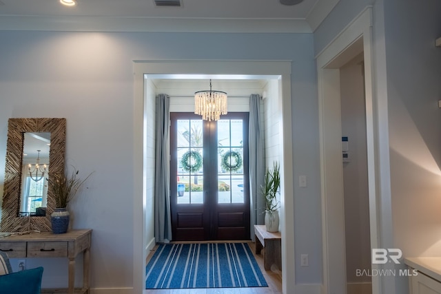 entryway with visible vents and a notable chandelier