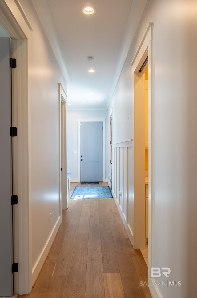 corridor with recessed lighting, baseboards, crown molding, and light wood finished floors