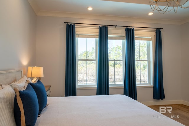 bedroom with baseboards, ornamental molding, wood finished floors, and recessed lighting